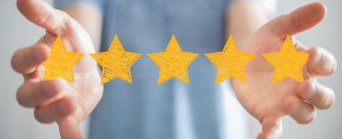 Businessman on blurred background rating with hand drawn stars.